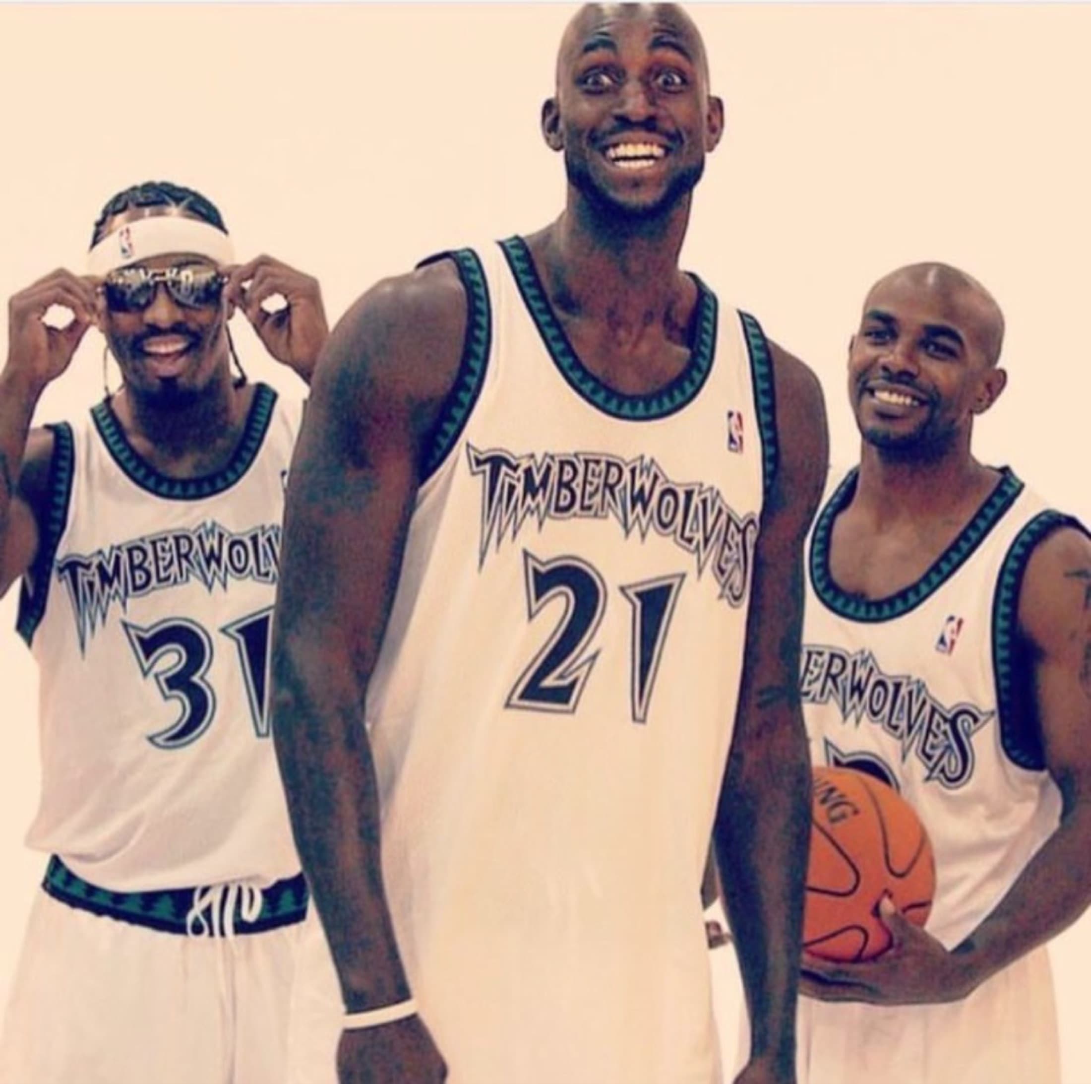 Archival photograph of Mike James with Minnesota Timberwolves teammates.